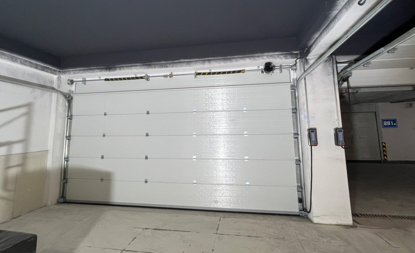 Sectional garage door for residential building