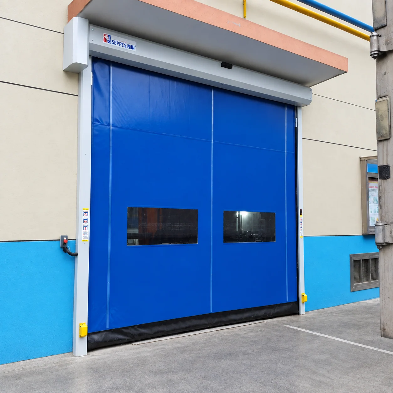 SEPPES blue automatic high speed door with an overhead activation sensor and two vision windows