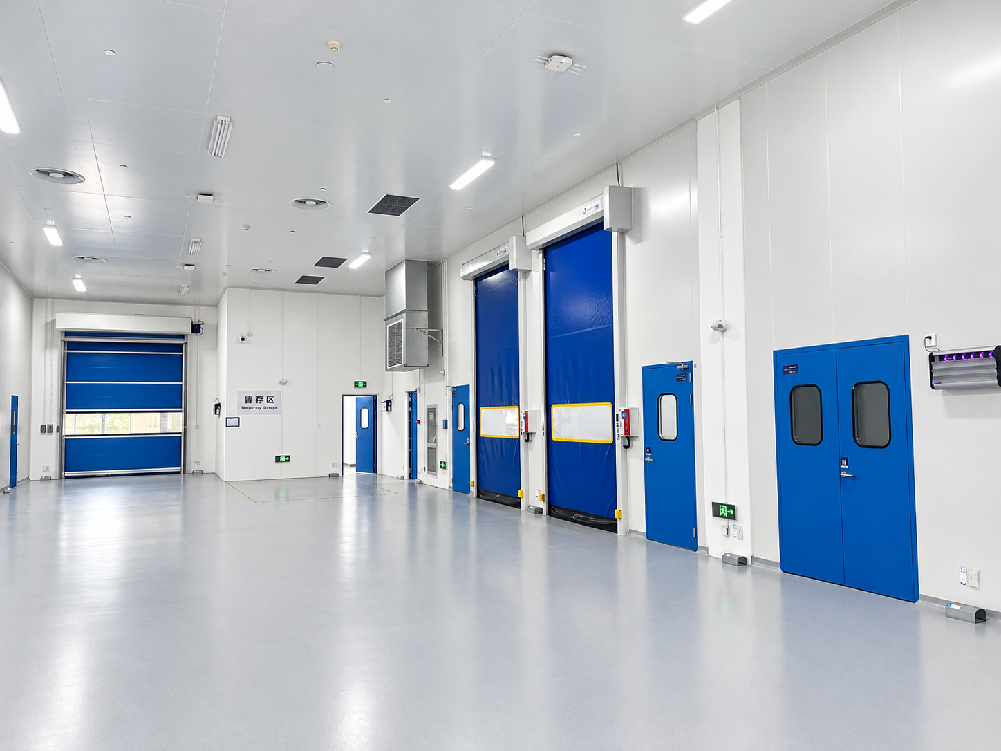 SEPPES cleanroom door manufacturer installation with blue high speed doors and separate personnel entrances, retouched installation photograph