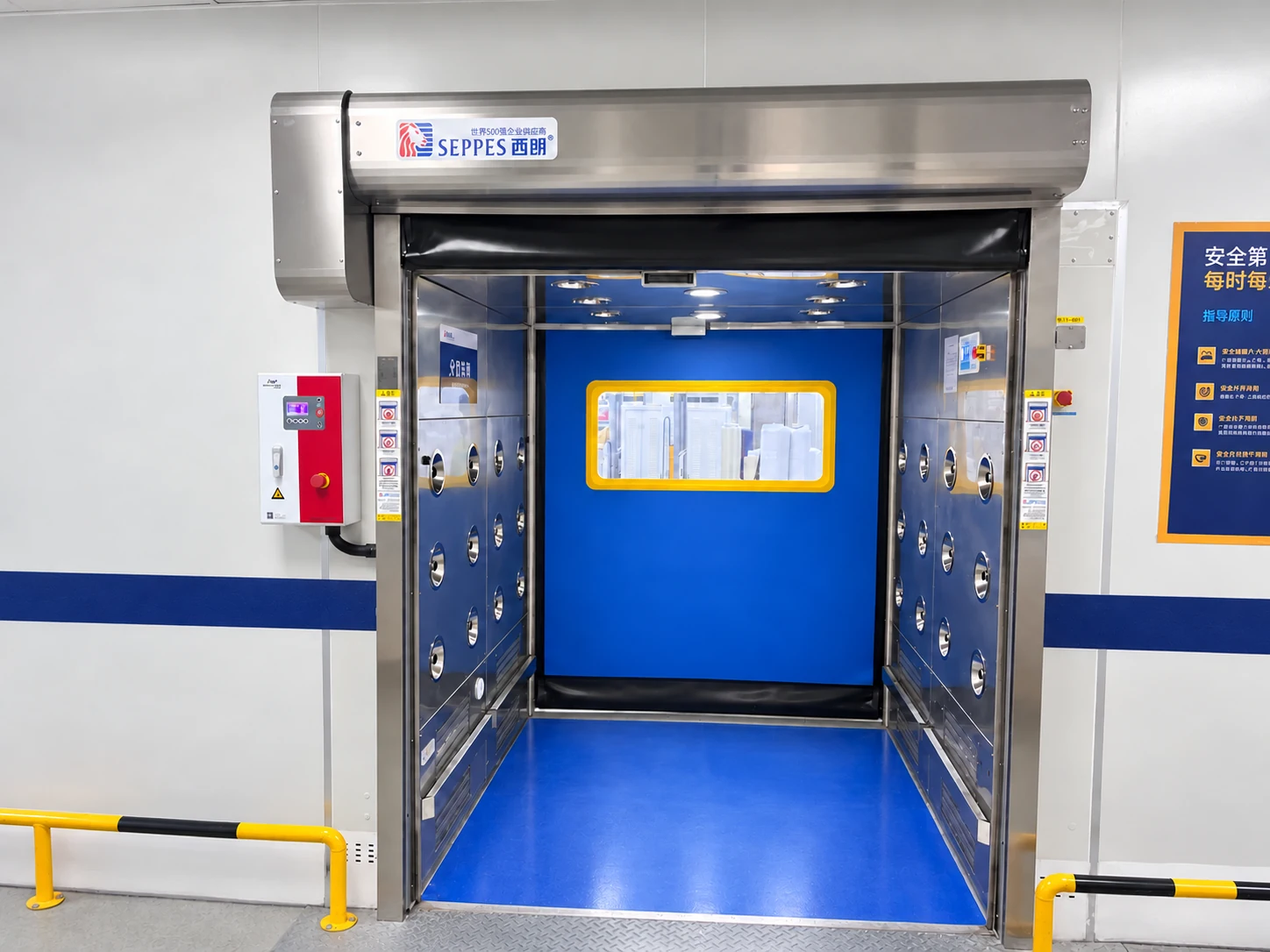 Clean room interlocking doors at an air-shower entrance with a blue door and stainless steel chamber