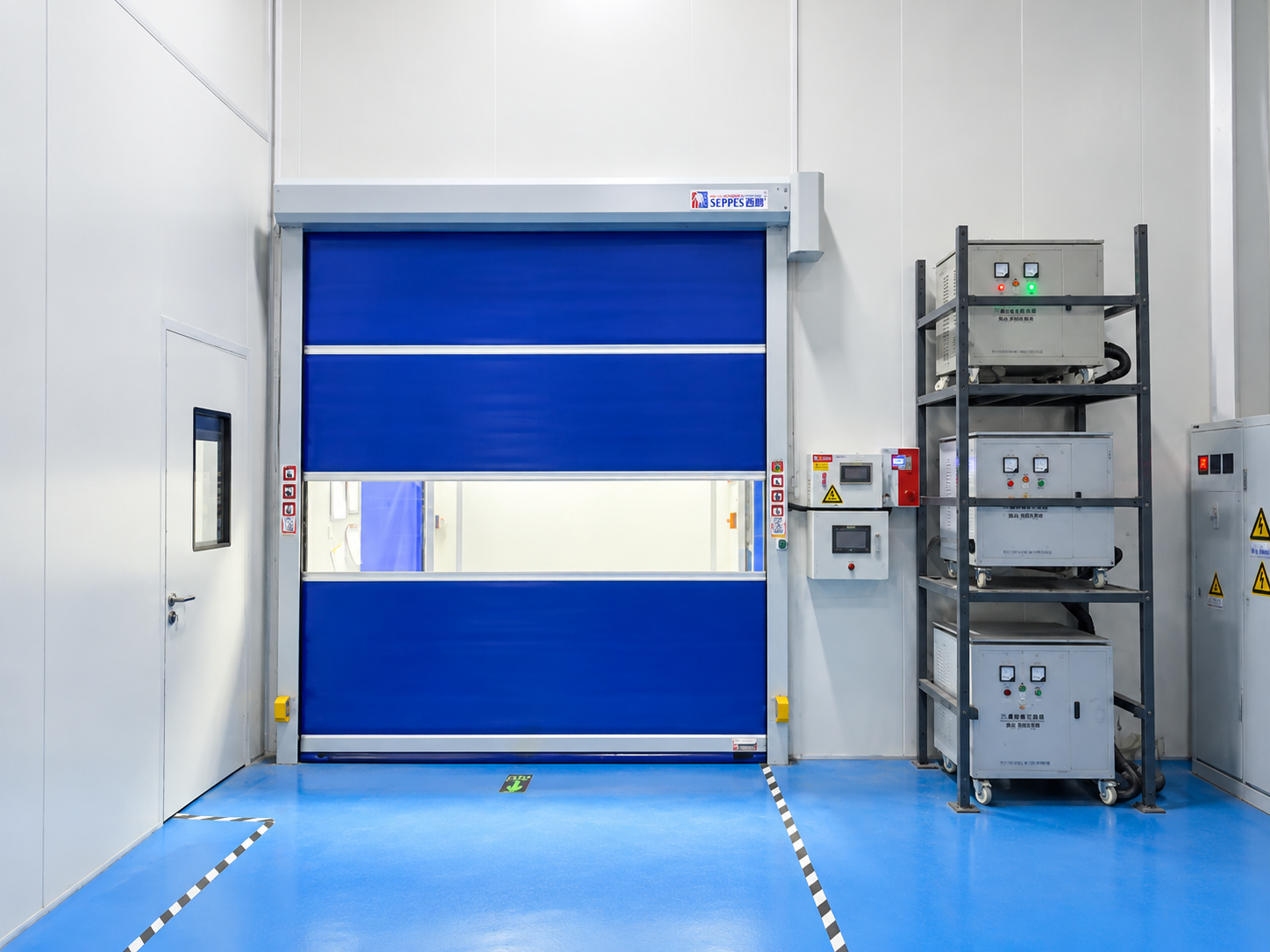 SEPPES workshop passage installation with a blue high speed door, horizontal vision panel and side control box