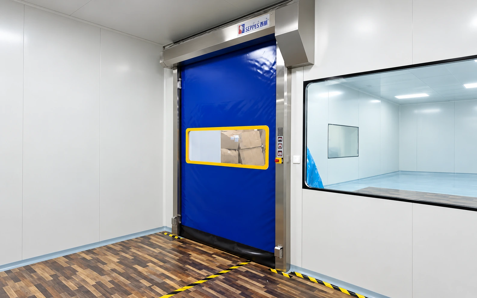 Restored photograph of hands free cleanroom doors with a blue curtain, yellow-bordered viewing panel and stainless steel frame